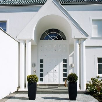 Entry of a modern white House with blue Sky